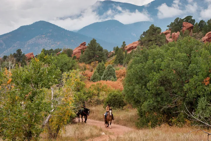 a group of people riding on the back of a horse